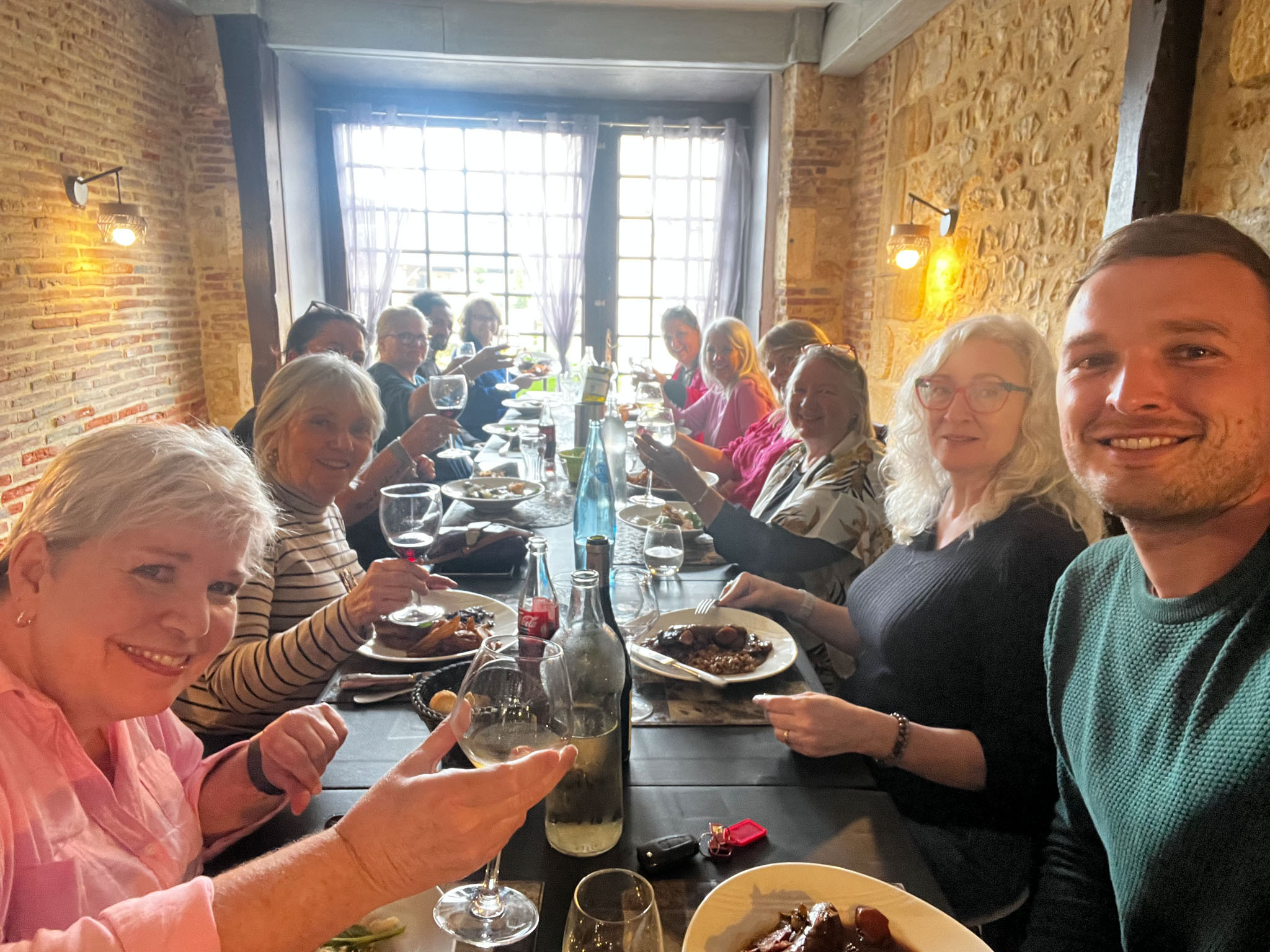 ardith Goodwin's group drinking Cahors and Bergerac wine at lunch